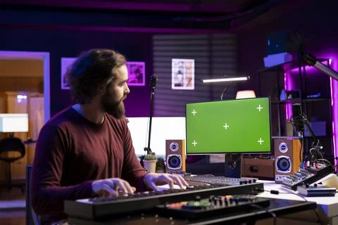 Audio engineer learning to work on electronic keyboard in home studio Fotos de archivo