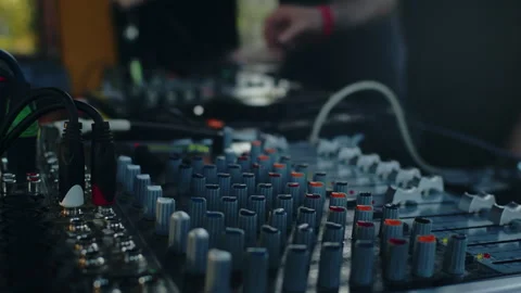 Audio engineer mixing music on analog soundboard Stock Footage 282723486