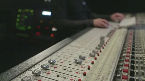 Audio engineer operating mixing console with hands Stock Footage 54425472
