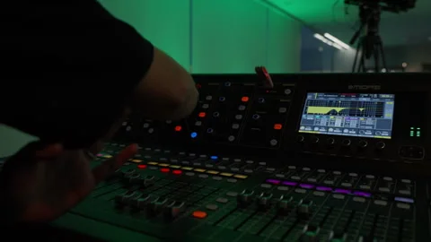 Audio engineer operating sound mixing console for event Stock Footage 335155674