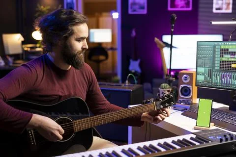 Audio engineer performing on guitar in his home studio 스톡 사진