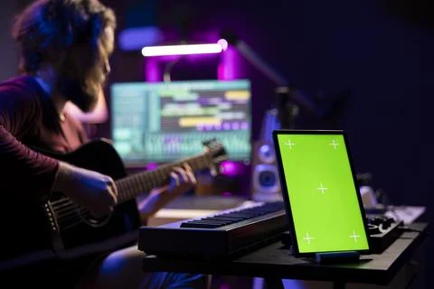 Audio engineer playing guitar and recording tunes on daw software Stock Photos