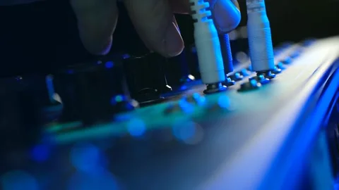 Audio engineer plugging jack cable into a sound mixer Stock Footage 337830940