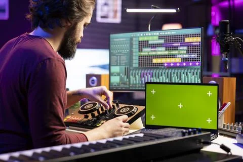 Audio engineer pushing pre amp knobs on mixing console in home studio 스톡 사진