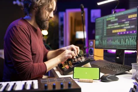 Audio engineer uses knobs on stereo gear for mixing and mastering session 스톡 사진