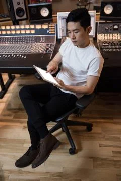 Audio engineer using digital tablet near sound mixer Stock Photos