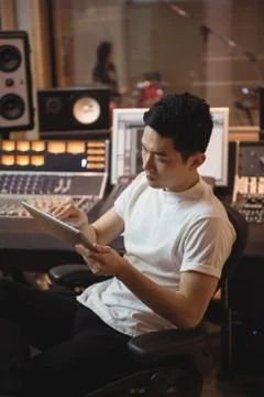 Audio engineer using digital tablet near sound mixer Stock Photos