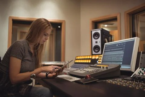 Audio engineer using digital tablet 스톡 사진