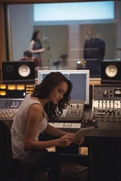 Audio engineer using digital tablet near sound mixer 스톡 사진