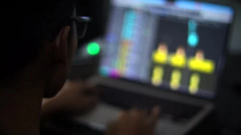 Audio Engineer Working with Digital Audio Workstation on Laptop Computer Stockbeeldmateriaal 340450073
