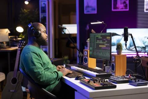 Audio engineer working on editing old recordings in home studio Foto stock