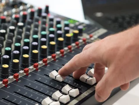 Audio engineer working on mixing console Фото