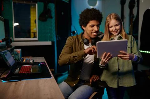 Audio engineer with young singer working in music recording studio Foto stock