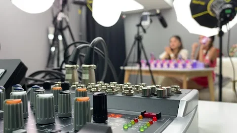 Audio equipment mixer console controller. Blurred live streamers in background Stock Footage 254153359
