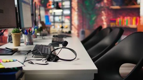 Audio headsets and compute peripherals on office desk, close up 写真素材