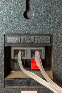 Audio input cables connected to the back panel of professional sound equipmen 库存照片
