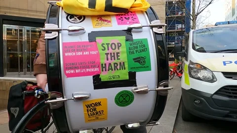 Audio, London, Drum close up with extinction rebellion logo and police car Video stock 238780494