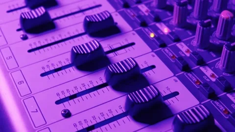 Audio Mixing Console Faders and Knobs Under Blue Studio Lighting Stock-Footage 334737136