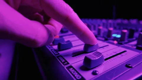 Audio Mixing Console Faders Sliding Upward Under Blue Ambient Light Stock Footage 334736625