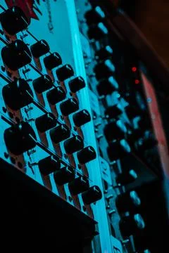 Audio mixing console knobs with blue/red studio lighting Stock Photos