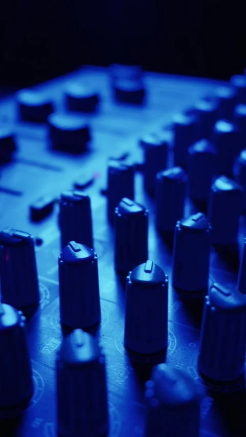 Audio Mixing Console Knobs Glowing Under Cinematic Neon Green Lighting Stock-Footage 334738946