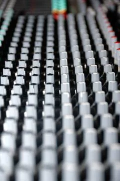 Audio mixing console in a recording studio. Faders and knobs of a sound mi... Stock Photos