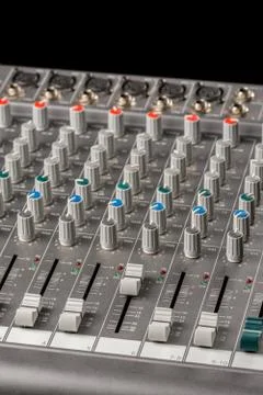 Audio mixing console with sliders and knobs on the channels. Stock Photos