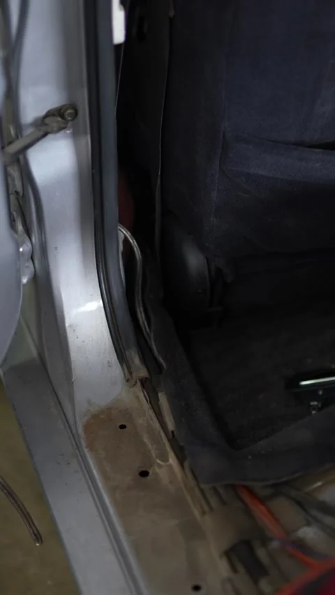 Audio power cables routed along a car floor sill panel. Stock Footage 344362387