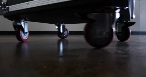Audio rack case spinning around close-up on coaster wheels travel the road Stock Footage 205802108