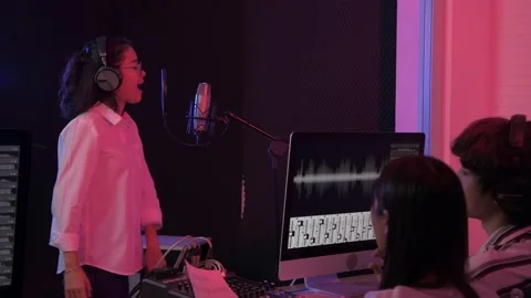 Audio recording concept of 4k Resolution. A young Asian singer is recording i Stock Footage 146491910