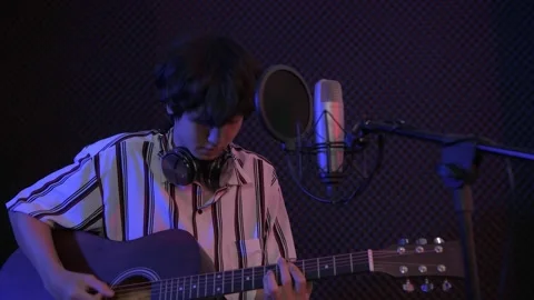 Audio recording concept of 4k Resolution. A solo singer is recording a song i Stock Footage 149333719