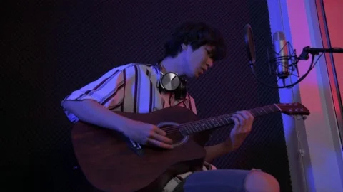 Audio recording concept of 4k Resolution. A solo singer is recording a song i Stock Footage 150705417