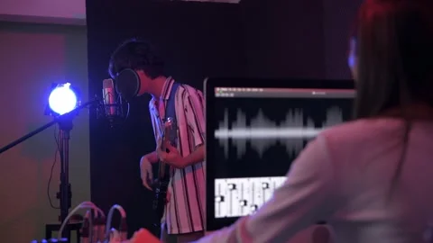 Audio recording concept of 4k Resolution. The artist is recording music in th Stock Footage 151835122