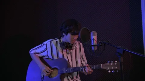 Audio recording concept of 4k Resolution. A solo singer is recording a song i Stock Footage 152518588