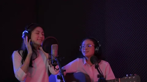 Audio recording concept of 4k Resolution. Young artist duo singing in the stu Stock Footage 152518603