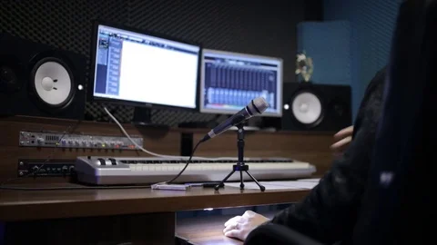 Audio recording professional adjusts large mixing board in recording studio Stock Footage 69907573