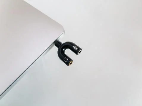 Audio Splitter 3.5mm Shape U For Microphone and Headphone Inserted in a Laptop Stock Photos
