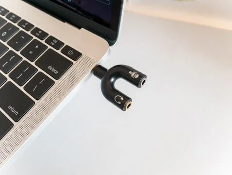 Audio Splitter 3.5mm Shape U For Microphone and Headphone Inserted in a Laptop Stock Photos