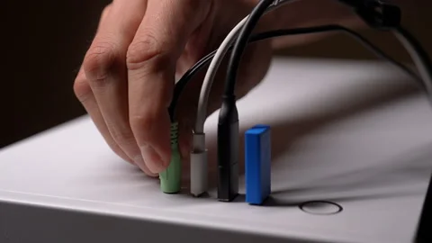 Audio technician connecting audio jack cable to computer port, other cables and Stock Footage 291272725