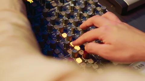Audio technician twisting pre amp knobs and buttons on board in control room 스톡 동영상 270505090
