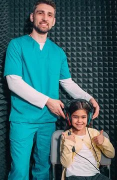 Audiometry test. Audiologist doing hearing test to a little girl, checking ch Fotos de archivo