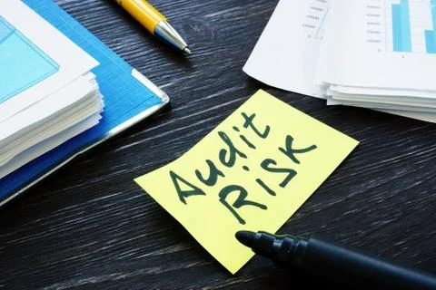 Audit risk memo and stack of papers with report. Stock Photos