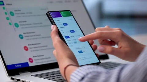 Auditor Carefully Reviews Security Logs On Smartphone Stock Footage 333399753