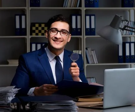 Auditor looking for errors in financial reporting for company Stock Photos