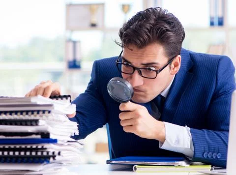 Auditor looking for errors in the financial statements 写真素材