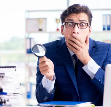 Auditor looking for errors in the financial statements 스톡 사진