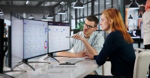 Auditor Reviews Multiple Computer Screens Carefully Tracking Corporate Compli Stock Photos