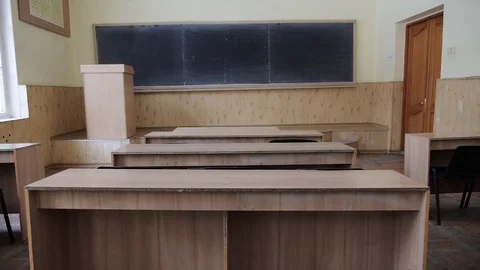 Auditorium, classroom, lecture hall in need of repair. Walls faded tables shabby Stock Footage 72699336