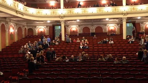 The auditorium of the opera house. People gather for a performance and sit in Stock Footage
