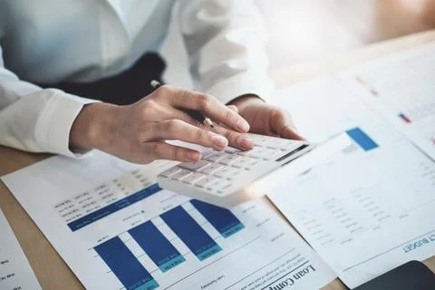 Auditors use budget document calculators to find annual budget disbursement.. Stock Photos